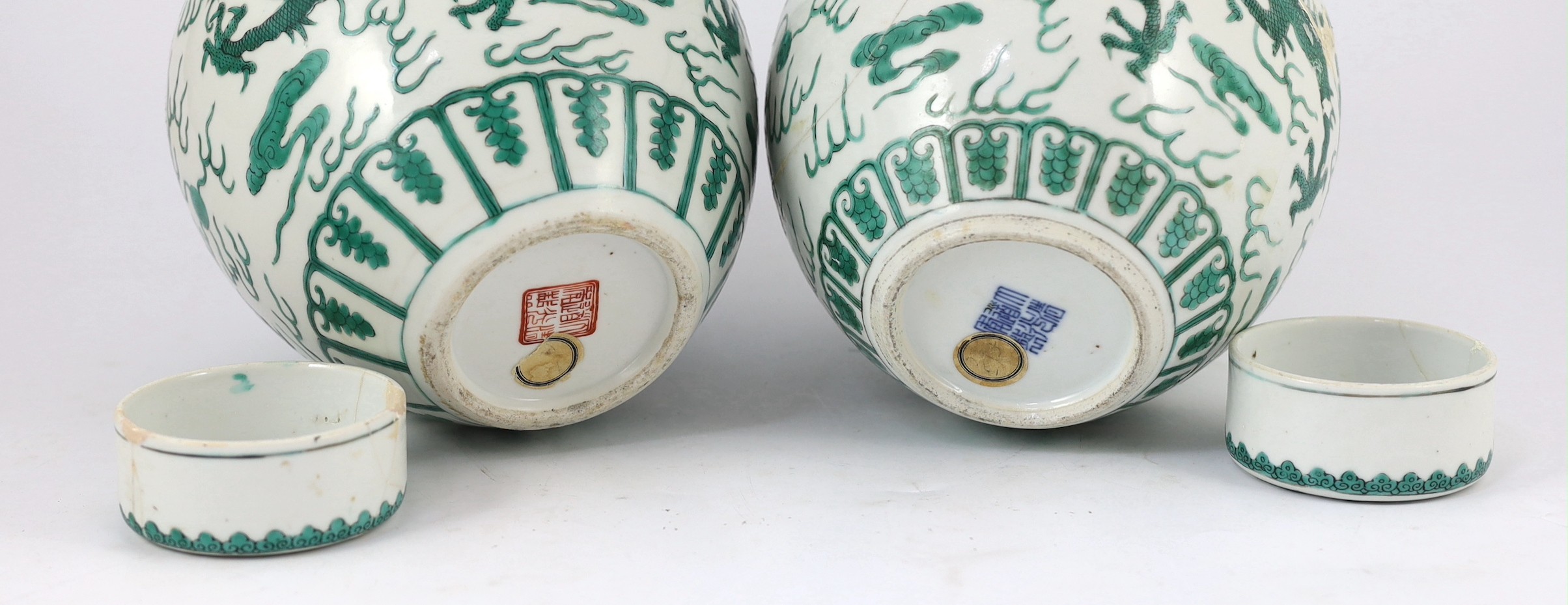 Two similar Chinese green enamelled ‘dragon’ jars and covers, Daoguang mark and period (1821-50), 21.5cm high, damaged and repaired